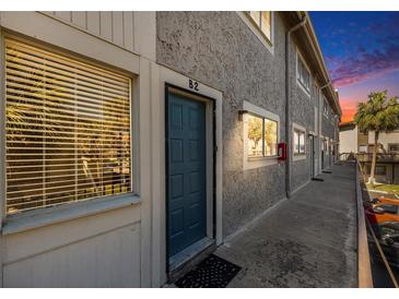 Condo exterior features a textured facade, modern windows, and well-lit walkway at 6311 Newtown Cir # 11B2, Tampa, FL 33615