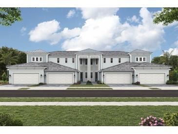 Charming townhome with a symmetrical facade, featuring a manicured lawn and inviting curb appeal at 12785 Jade Empress Loop # 102, Venice, FL 34293