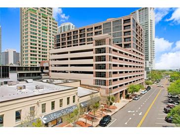Exterior view of a multi-story building with brick and beige accents, street view, and surrounding high-rise buildings at 175 2Nd S St # 1014, St Petersburg, FL 33701