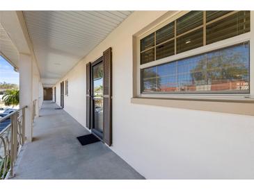 Balcony entrance to condo with large window allowing for lots of natural light at 19029 Us Highway 19 N # 2-17, Clearwater, FL 33764