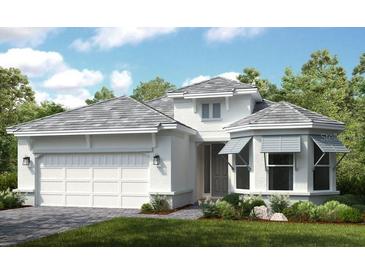 Charming single-Gathering home featuring a welcoming two-car garage and manicured landscaping at 29845 Imperati Blvd, Wesley Chapel, FL 33543