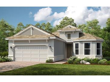 Charming single story home with a two car garage and well manicured landscaping at 29863 Imperati Blvd, Wesley Chapel, FL 33543
