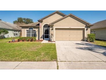 Charming single-story home with a well-manicured lawn, two car garage and welcoming curb appeal at 9729 Patrician Dr, New Port Richey, FL 34655