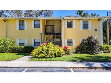 Inviting condo exterior with well-maintained landscaping, sidewalk, and charming architectural details at 3001 58Th S Ave # 912, St Petersburg, FL 33712