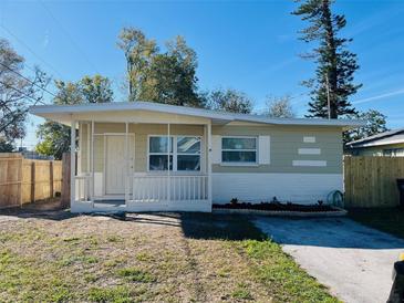 Charming single-story home with front porch and well-lit windows, complemented by a tidy front yard at 4108 55Th N Ave, St Petersburg, FL 33714