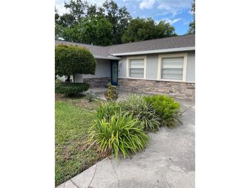 Charming single-story home with a well-manicured lawn and stone accents at 2412 Giddens Ave, Seffner, FL 33584