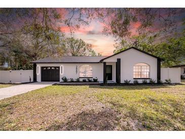 Charming single-story home featuring a freshly painted exterior, manicured lawn, and a convenient one-car garage at 2887 North Rd, Clearwater, FL 33760