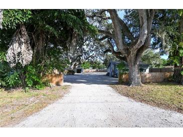 Long driveway leads to a cozy home with mature landscaping and a fenced yard at 3515 18Th E St, Bradenton, FL 34208