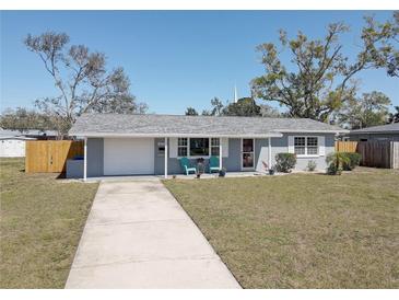 Charming single-story home featuring a well-manicured lawn and a long driveway leading to an attached garage at 4375 37Th N Ave, St Petersburg, FL 33713