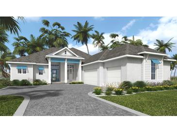 Charming single-story home boasts lush landscaping, a paved driveway, and a welcoming covered porch at 5050 Elm Leaf Dr, Brooksville, FL 34601