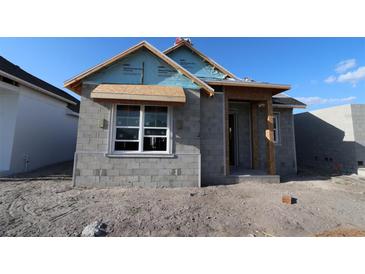 Exterior view of a block constructed home in process of being built with exposed beams and window frame at 7263 Kodiak Ln, Sarasota, FL 34240