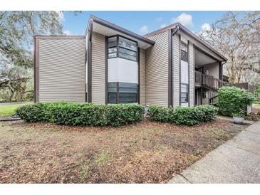 Attractive exterior of a two-story home with a landscaped yard and unique architectural details at 12025 Environmental Dr # 5, New Port Richey, FL 34654