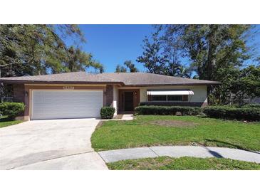 Charming single-story home featuring a well-maintained lawn and attached two-car garage at 2457 Orangepointe Ave, Palm Harbor, FL 34683