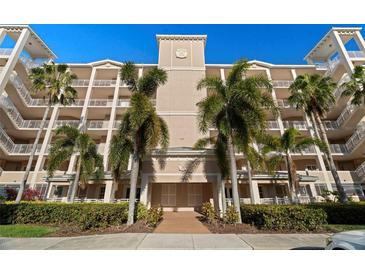 Beautiful condominium exterior with balconies and lush tropical landscaping at 7069 Key Haven Rd # 205, Seminole, FL 33777