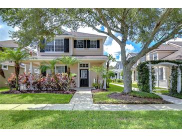 Charming two-story home with a landscaped front yard, mature trees, and inviting curb appeal in a desirable community at 8907 Ashford Gables, Tampa, FL 33626