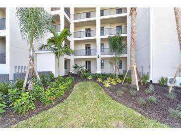 Exterior view of building with lush landscaping featuring palm trees and manicured lawn at 17724 Gawthrop Dr # 402, Bradenton, FL 34211