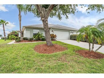 Charming single-story home featuring a well-manicured lawn and mature trees in a peaceful neighborhood setting at 29312 Marker Loop, San Antonio, FL 33576