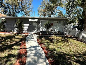 Charming single-story home with a well-manicured lawn, a walkway, and tasteful landscaping at 5007 2Nd S Ave, St Petersburg, FL 33707