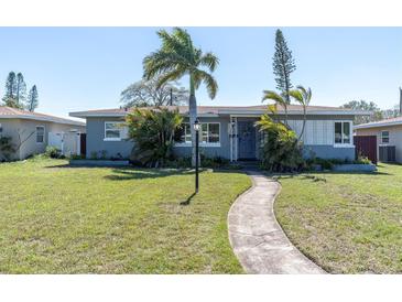 Charming single-story home with a well-manicured lawn and tropical landscaping, creating a welcoming curb appeal at 6618 3Rd N Ave, St Petersburg, FL 33710