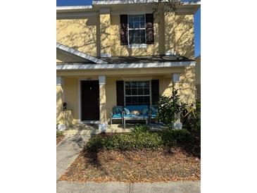 Charming two-story townhouse with covered front porch and seating area at 4632 Chatterton Way, Riverview, FL 33578