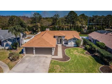 A well-maintained single Gathering home with an attached two car garage and manicured lawn at 5342 Sagamore Ct, New Port Richey, FL 34655