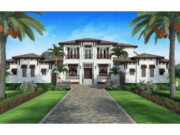 Stunning two-story home features manicured landscaping, symmetrical design, a brick driveway, and balcony at 1 Avonwood, Tampa, FL 33625