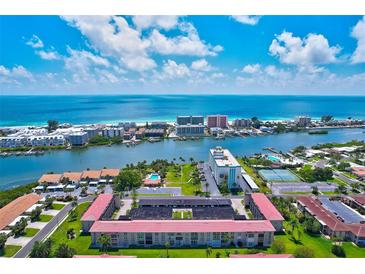 Breathtaking aerial view of a beachfront community with stunning blue ocean and lush tropical surroundings at 10215 Regal Dr # 45, Largo, FL 33774