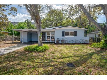 Charming one-story home with a well-maintained front yard and covered parking at 2918 W Ellis Dr, Tampa, FL 33611