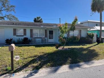 Charming one-story home with a well-maintained lawn and inviting curb appeal at 425 Highland Ct, Dunedin, FL 34698