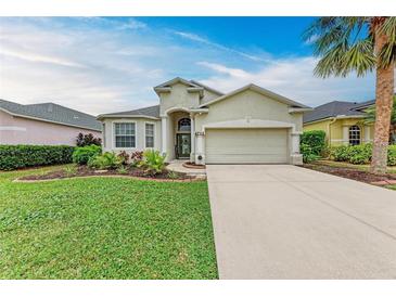 Charming single-story home featuring a two-car garage, manicured lawn, and a welcoming, landscaped front yard at 4712 Trout River Xing, Ellenton, FL 34222