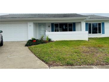 Charming single story home with manicured lawn and blue shutters at 9015 41St N St, Pinellas Park, FL 33782