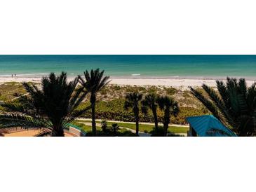 Beautiful beachfront view with swaying palm trees, white sand and emerald-colored ocean water at 1560 Gulf Blvd # 502, Clearwater Beach, FL 33767