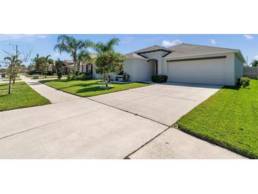 Charming single-story home with a well-manicured front yard and spacious driveway at 1615 Redmond Brook Ln, Ruskin, FL 33570