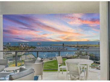 Relax on the balcony with seating and stunning views of the water and colorful sunset at 301 1St S St # 1201, St Petersburg, FL 33701