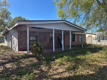 Modest single-story brick home with covered porch, offering potential for renovation and personalization at 3904 W Hamilton Ave, Tampa, FL 33614