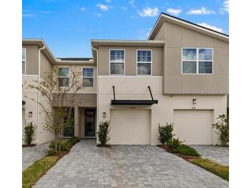 Attractive townhome with a well-maintained brick driveway and integrated garages at 4212 Cloud Hopper Way, Lutz, FL 33559