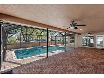 Screened lanai featuring a covered patio, beautiful pavers, and a sparkling pool at 902 Marco Ne Dr, St Petersburg, FL 33702
