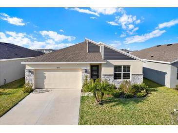 Charming single Gathering home with a well-manicured lawn and a two car garage in a suburban community at 31879 Treasure Dock Isle, Wesley Chapel, FL 33545