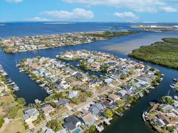 Beautiful aerial view showcasing the waterfront home and its access to the bay at 6606 Dolphin Cove Dr, Apollo Beach, FL 33572