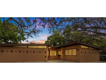 Charming exterior featuring stylish architectural details and lush trees, enhancing the home's curb appeal and setting at 1301 45Th N Ave, St Petersburg, FL 33703