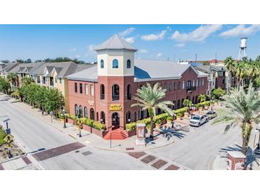 Corner building with red brick, a charming tower, street parking, and a view of the nearby water tower at 1810 E Palm Ave # 4304, Tampa, FL 33605