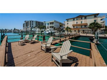 Beautiful waterfront property featuring a private dock with chairs and stunning views of the harbor at 479 E Shore Dr # 8, Clearwater, FL 33767