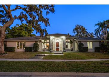 Stunning exterior of this well maintained home with mature landscaping and a stone entryway at 217 Manatee Rd, Belleair, FL 33756