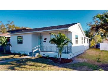 Charming white home featuring a quaint front porch and beautiful landscaping at 4586 12Th N Ave, St Petersburg, FL 33713