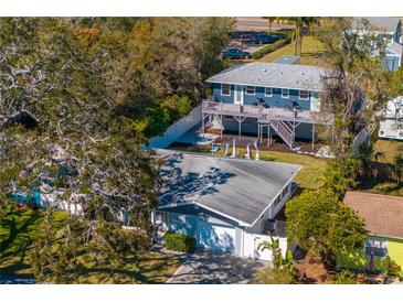 Aerial view showcases lush greenery, two-story home with a balcony, and charming single-story home at 5713 23Rd S Ave, Gulfport, FL 33707