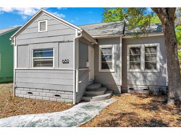 Close-up of gray house featuring porch, windows, steps, and visible house number at 689 Paris S Ave, St Petersburg, FL 33701