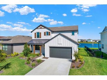 Charming two-story home boasts a modern farmhouse aesthetic with a well-manicured lawn at 8337 Abalone Loop, Parrish, FL 34219