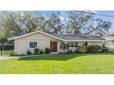 Charming single-story home with a lush green lawn and mature trees in a desirable neighborhood at 217 2Nd Sw St, Largo, FL 33770