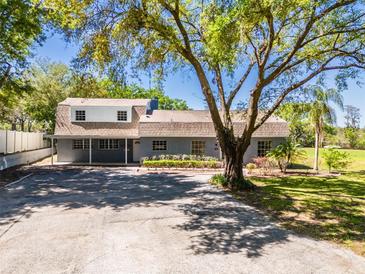 Charming home boasts a large front yard, mature trees, and ample parking space at 498 Lakewood Dr, Brandon, FL 33510