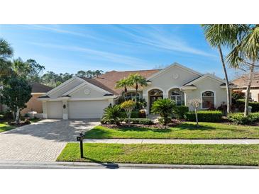 Charming home with a well-manicured lawn, mature landscaping, and a welcoming two-car garage at 10561 Greencrest Dr, Tampa, FL 33626